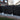 Screen With Envy black composite garden fence with decorative trellis panels installed in a residential backyard.